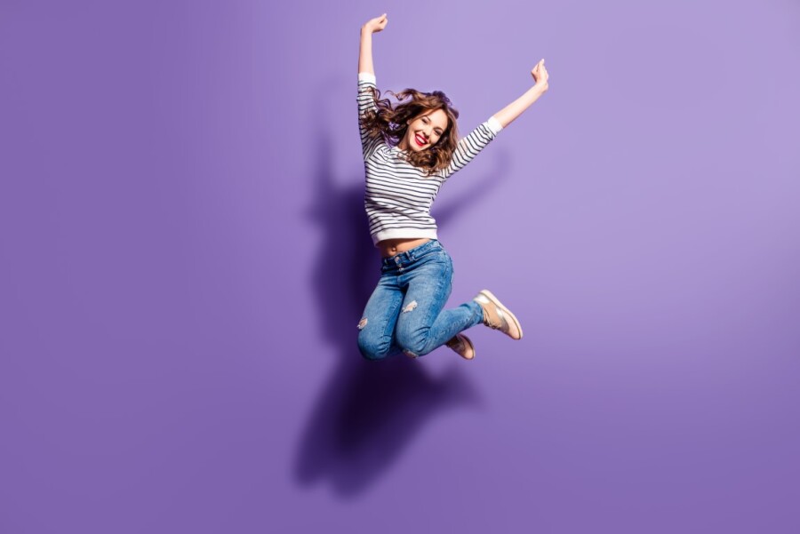 девушка прыгает на фиолетовом фоне